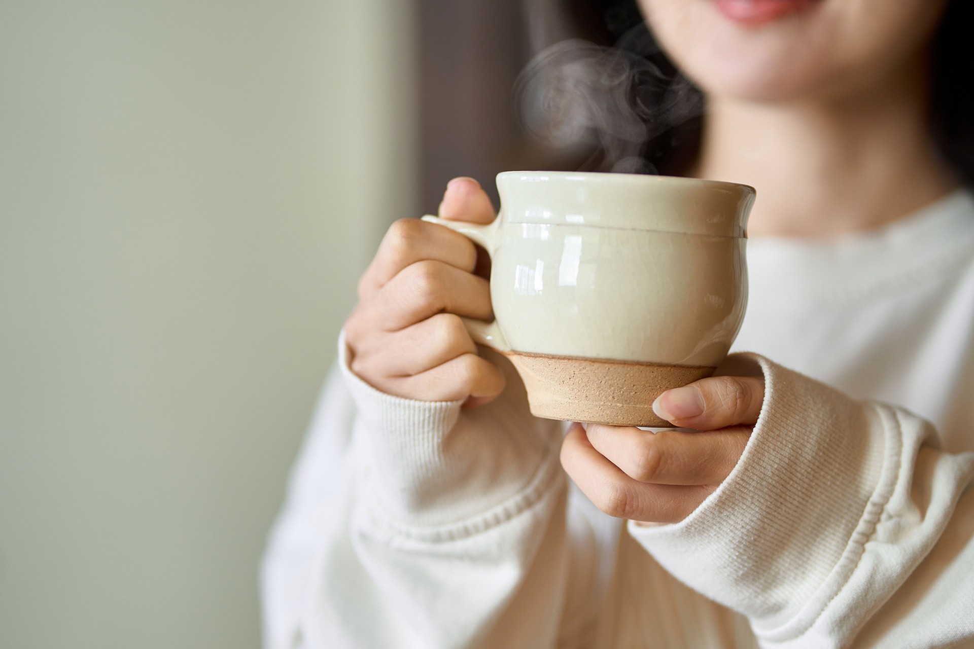 Asian woman relaxing with a drink